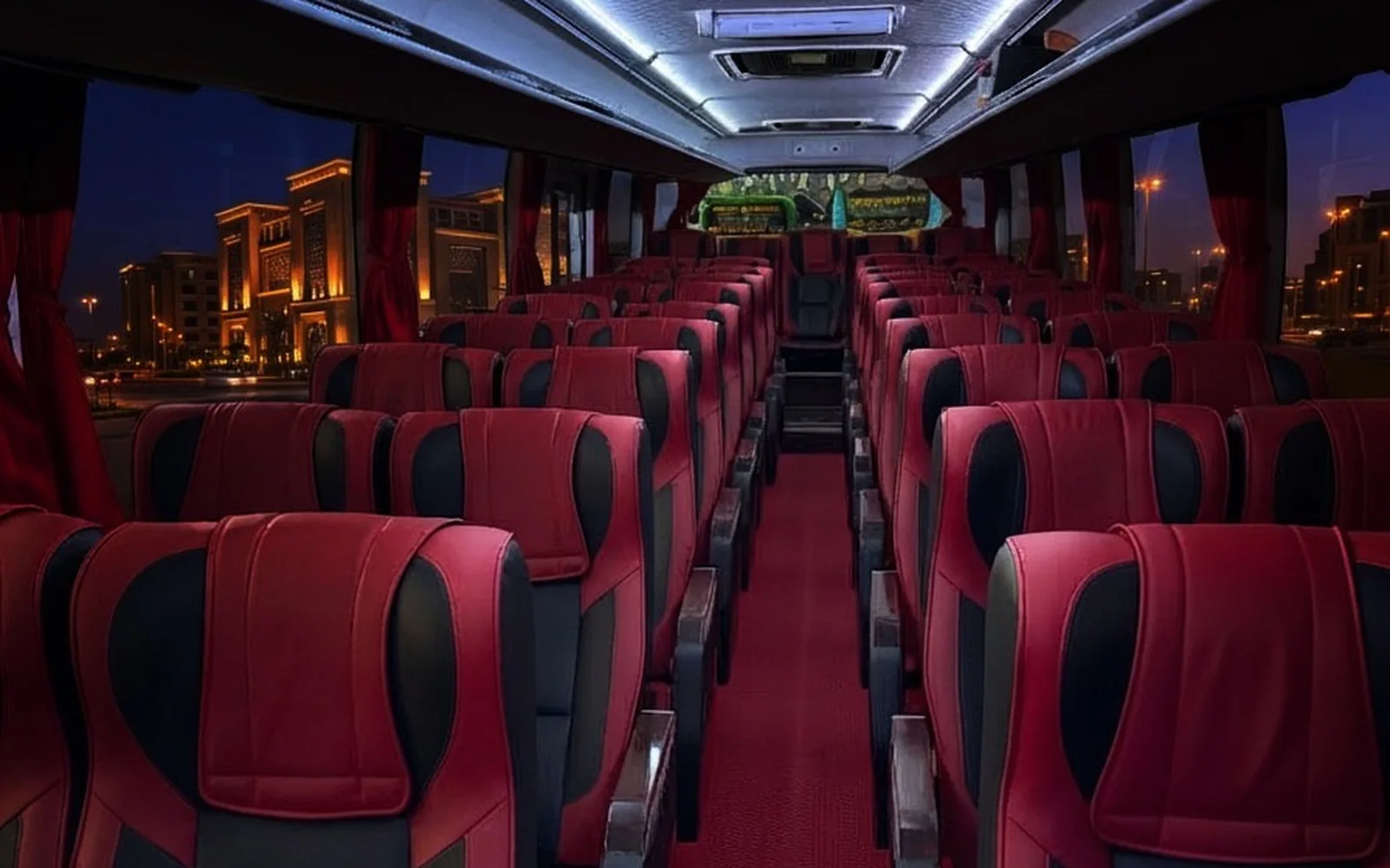 Executive cabin: red and black two-by-two seats under blue ceiling lighting